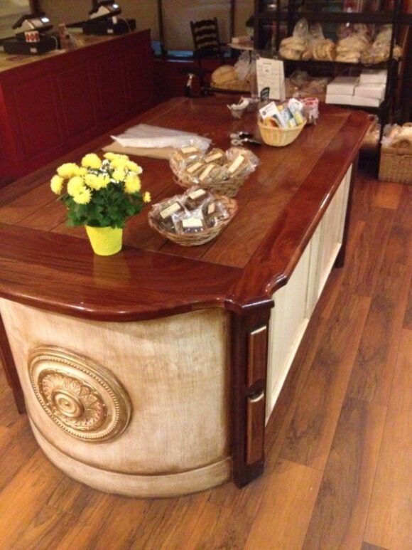 Mahogany and paint make this island display and storage cabinet a visual treat, next to the baked goods 
